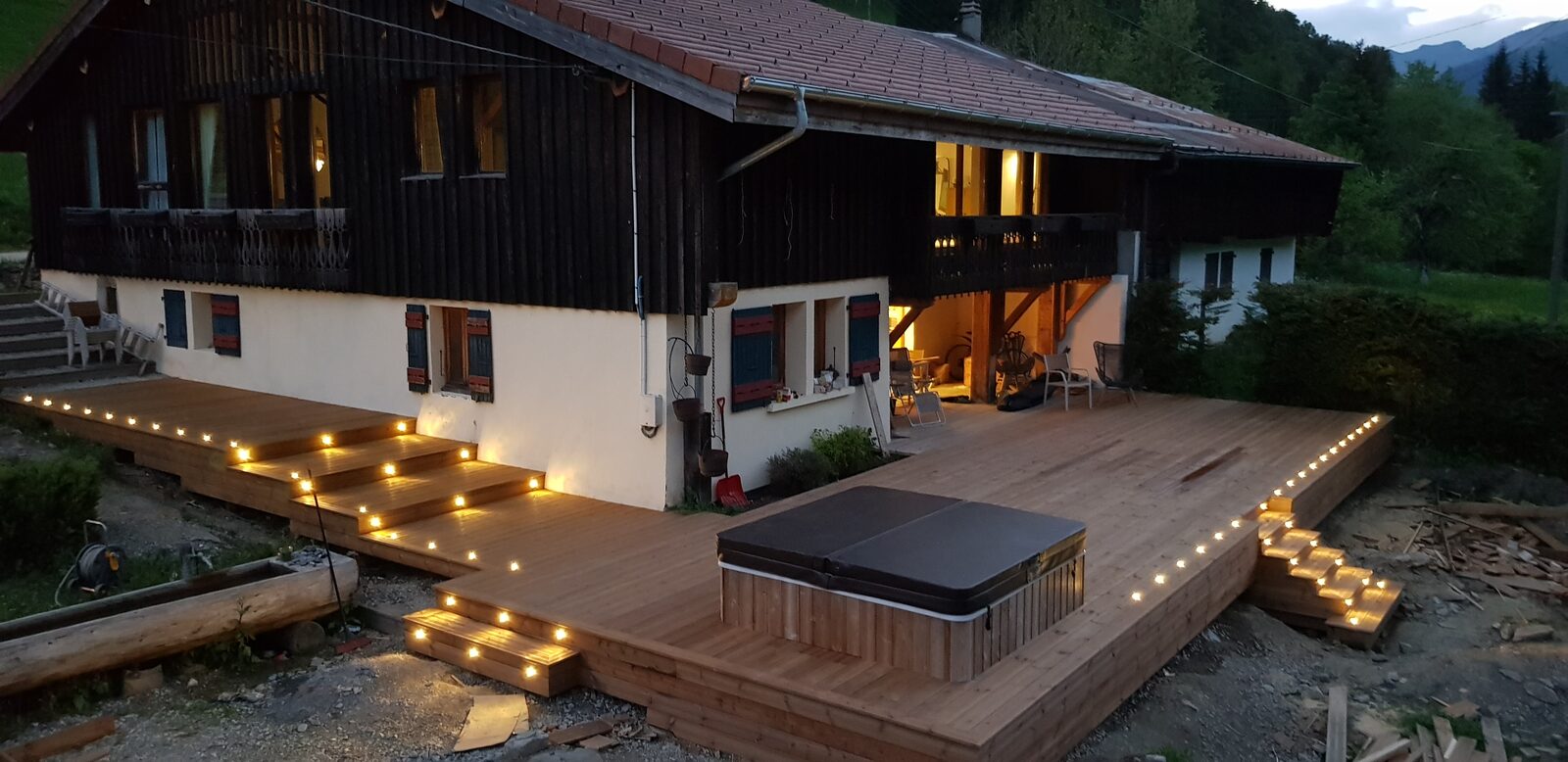 Modern chalet with terrace at dusk