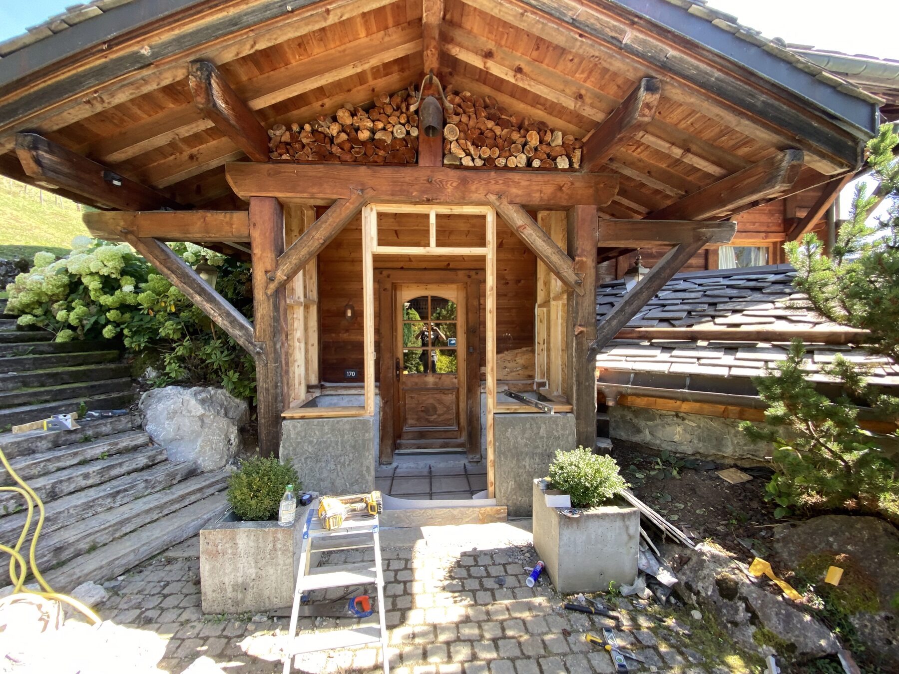 Traditional Savoyard chalet entrance with log store