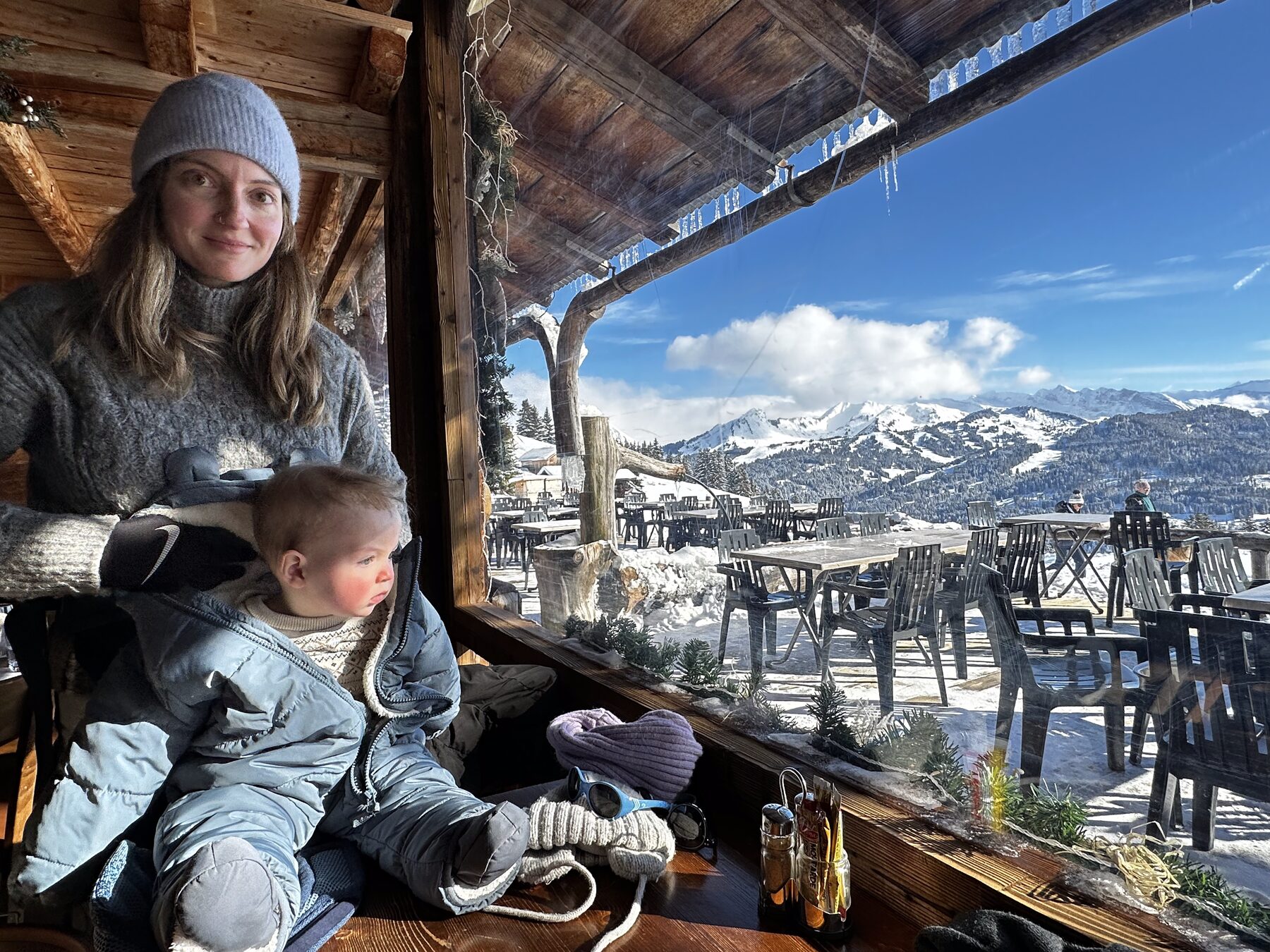 Kate and family on a chalet balcony above the valley