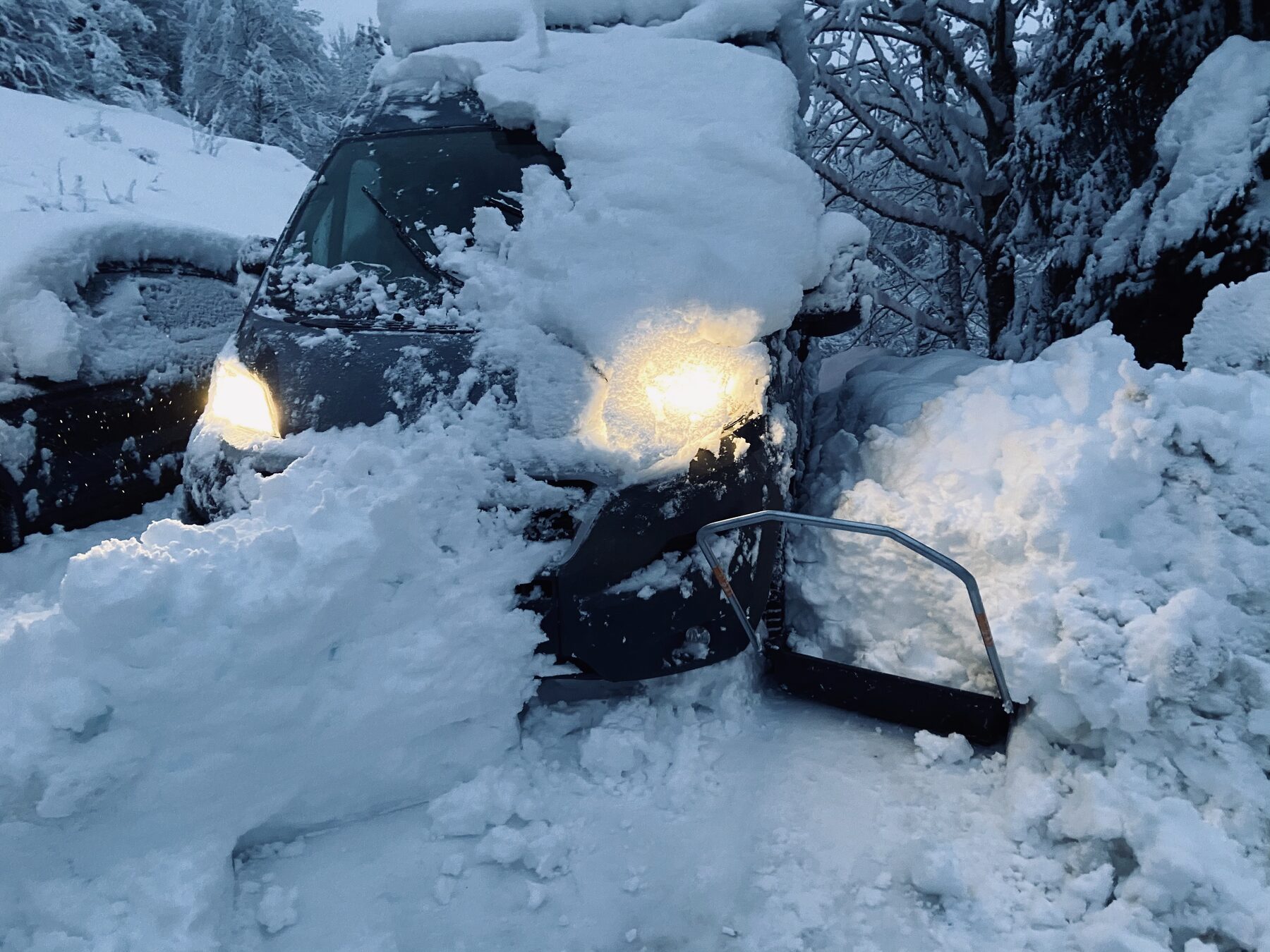 Snowmobile in deep snow at night